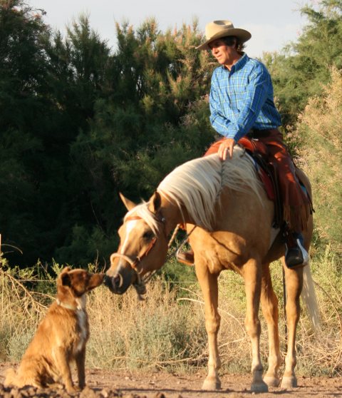 David Kaden trail riding with his dog Boogie alongside in a TW Saddlery saddle