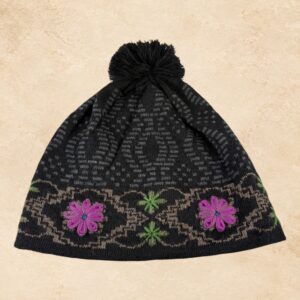 Black alpaca knit beanie with pink floral embroidery, green accents and black pom-pom