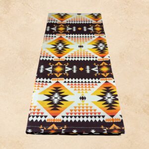 Southwestern geometric tea towel featuring yellow, orange, brown, black, and cream patterns.