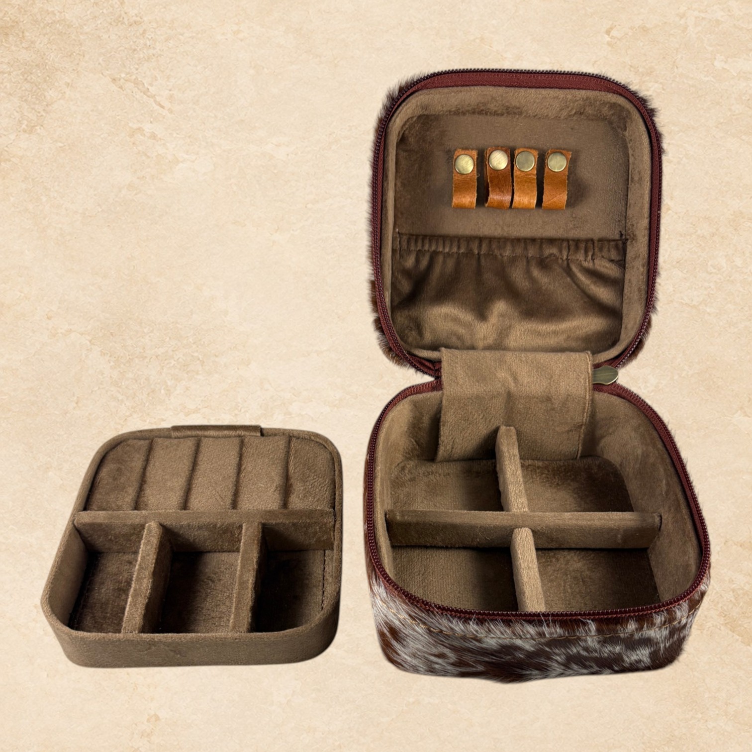 Open brown hide jewelry organizer with soft lined interior, divided compartments, ring holders, and removable insert.