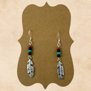Desert Feather Earrings with silver-tone feather charms and turquoise, brown and rust-colored beads on silver fishhook ear wires.