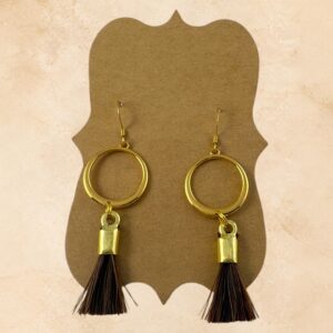 Golden Lasso horsehair earrings with gold-tone circular hoops and dark brown horsehair tassels.