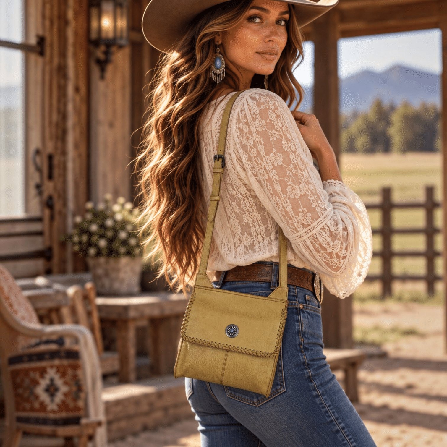 Golden tan Western crossbody purse with hand-laced edges and turquoise accent concho