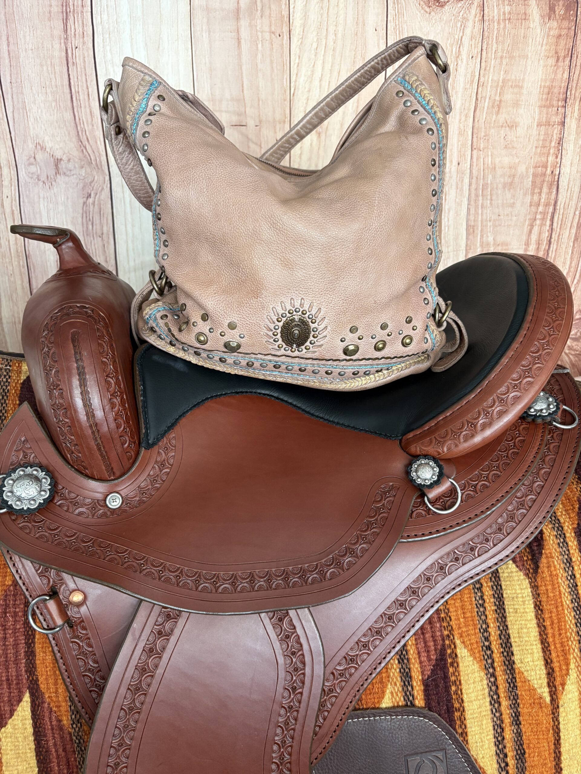 Brown Western purse with turquoise stitching, studded trim, and Southwestern detailing