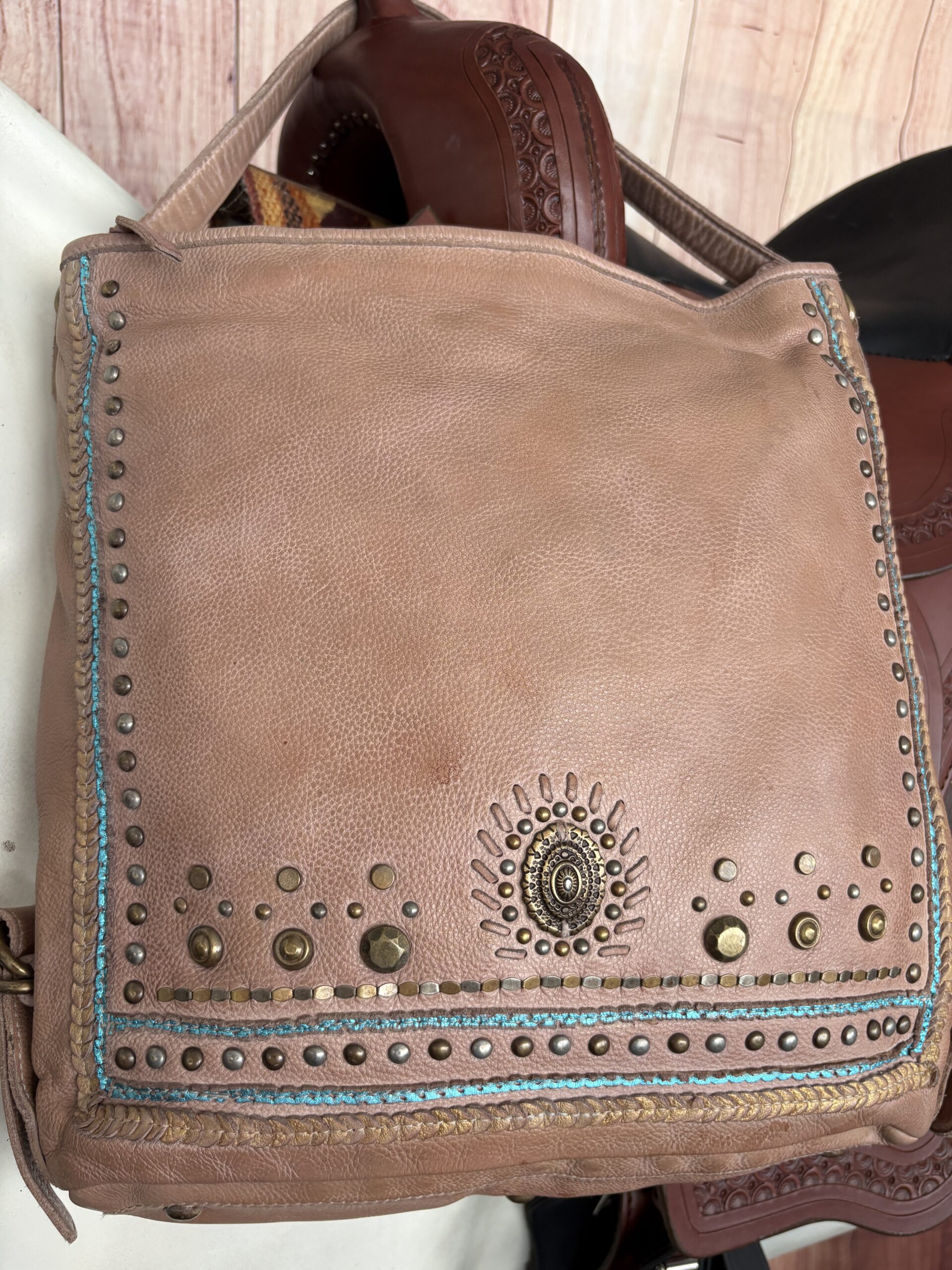Brown Western purse with turquoise stitching, studded trim, and Southwestern detailing