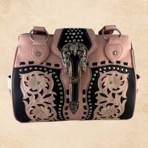 Blush pink and black purse with floral detailing, silver-tone studs, decorative stitching, and an ornate buckle accent.