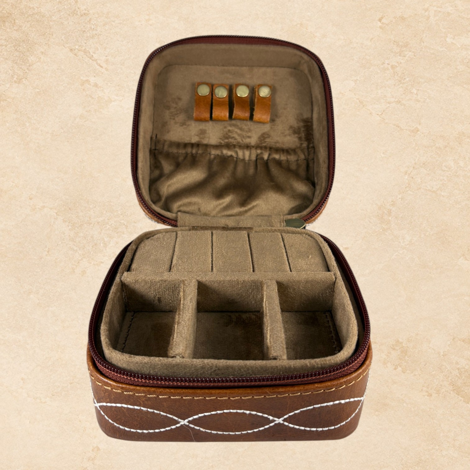 Brown Desert Stitch jewelry box open with soft interior, divided compartments, and jewelry holder loops.