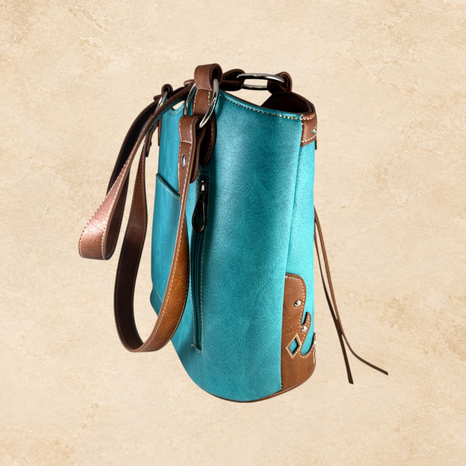 Turquoise and brown purse with intricate Southwestern detailing, silver-tone studs, decorative stitching, and brown leather-look accents.