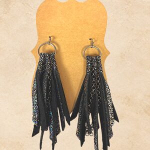 Black fringe earrings with shimmering metallic accents, chain details, and silver-tone hoops.
