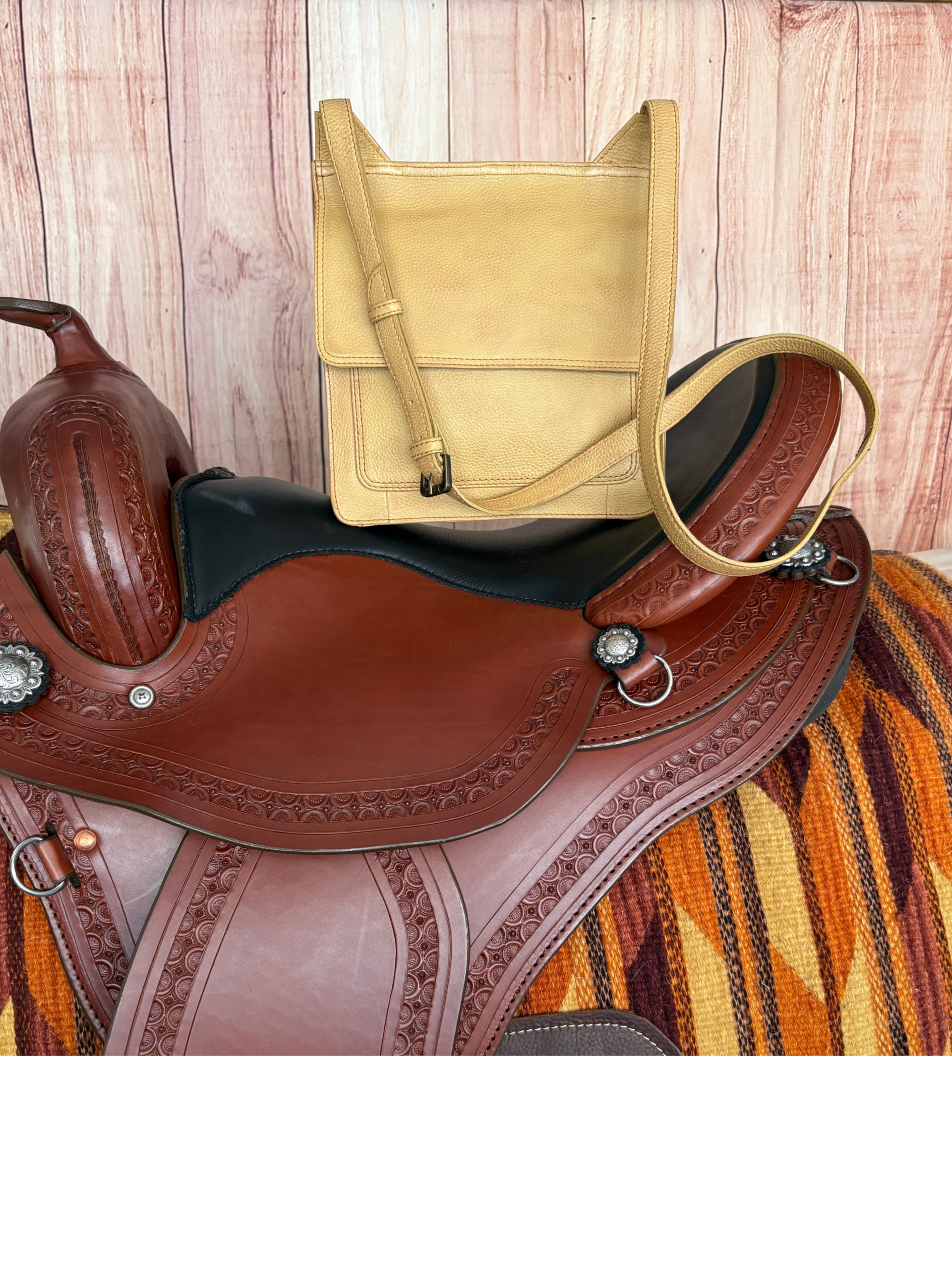 Golden tan Western crossbody purse with hand-laced edges and turquoise accent concho