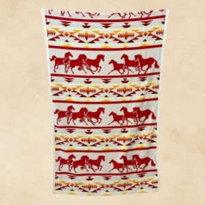 Sunset Stampede western beach towel with red running horses and southwestern geometric pattern in red, orange, gold and cream