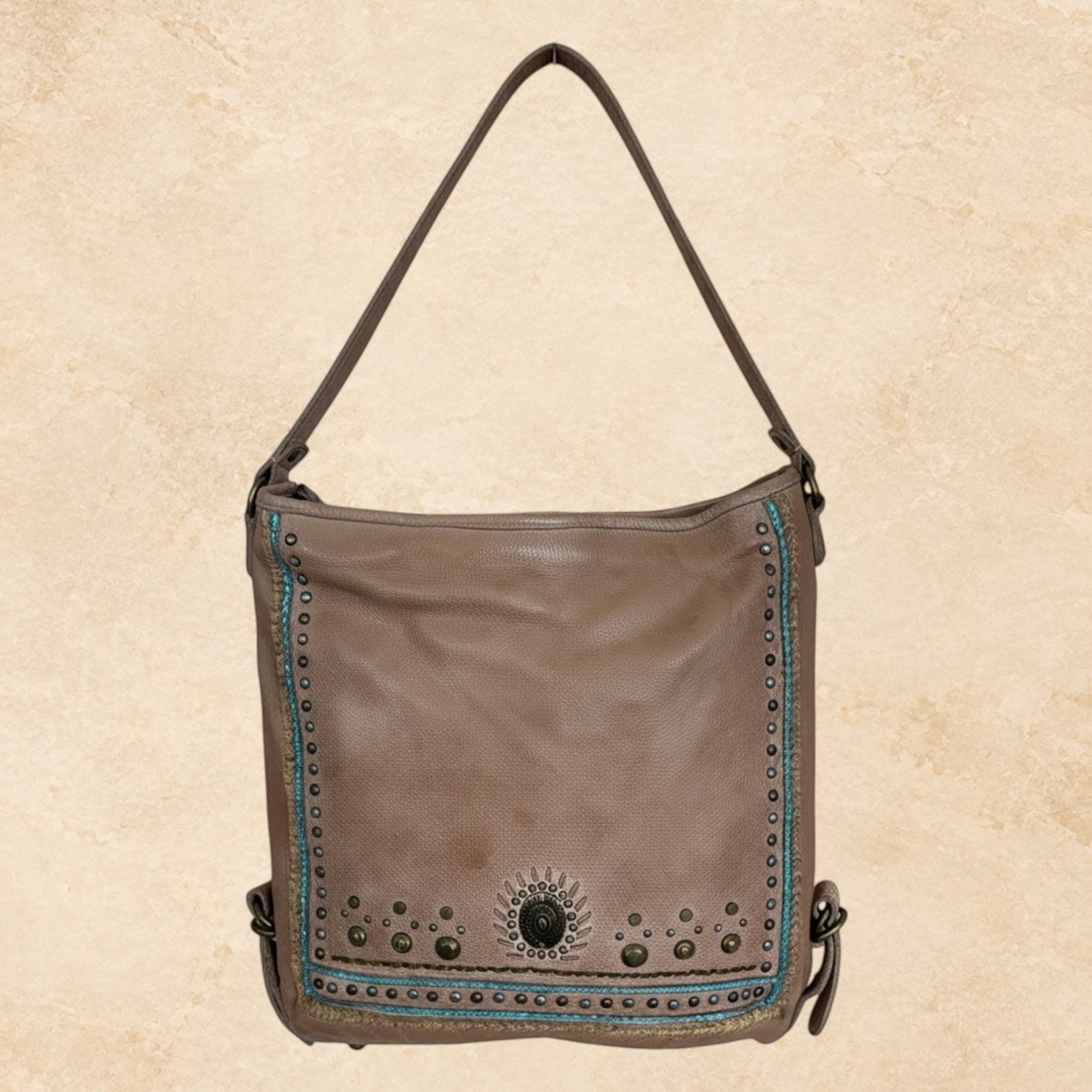 Brown Western purse with turquoise stitching, studded trim, and Southwestern detailing