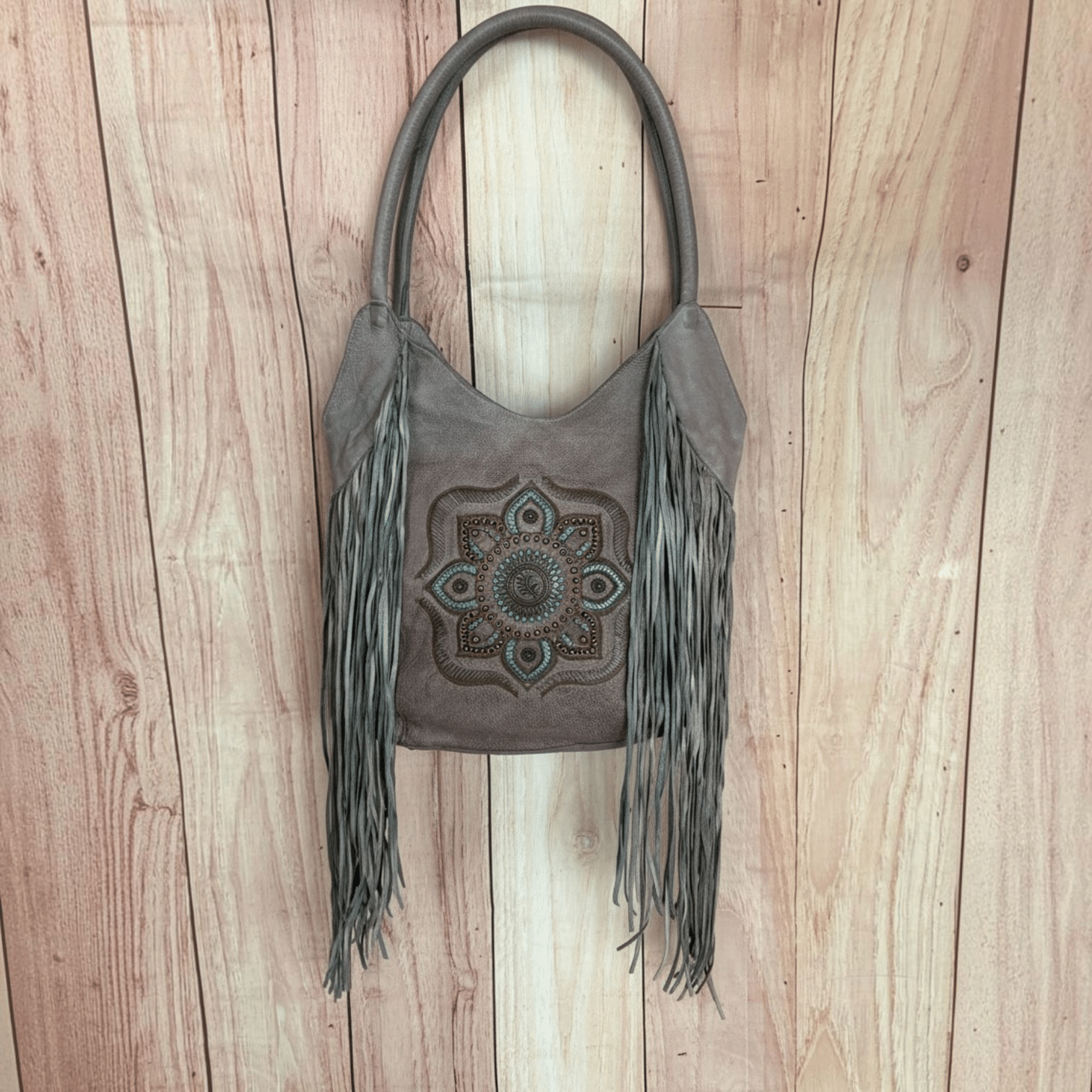 One-of-a-kind handmade taupe leather Western purse with long fringe and turquoise detailing.