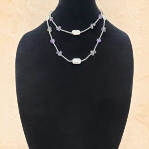 Lavender Pearl long beaded necklace featuring soft lavender beads, iridescent crystal accents, white pearl-style beads, and delicate silver-toned seed beads. Versatile continuous strand that can be worn long or doubled for a layered look.