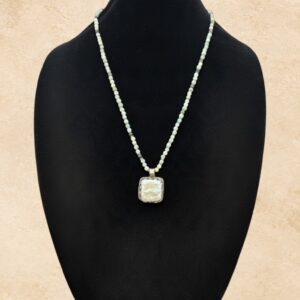 Mother Of Pearl And Mint necklace featuring a luminous square Mother of Pearl pendant framed in ornate Tibetan silver with decorative detailing on the reverse. The necklace features soft mint-green Amazonite beads, natural stone variations, and delicate silver-toned accents.