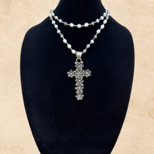 Pearls of Grace necklace featuring a beautifully detailed silver-toned floral cross pendant adorned with raised flower accents. The necklace is crafted with lustrous freshwater pearls and shimmering faceted crystal beads, individually connected by delicate silver-toned links. The reverse side of the cross has a smooth, undecorated finish.